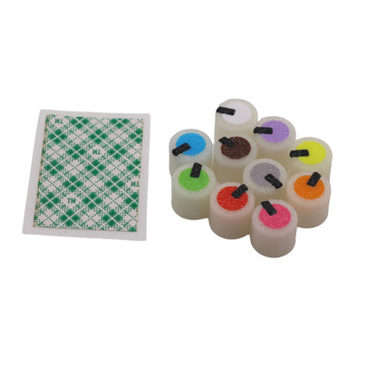 Set of colorful dice with a green and white checkered card on a white background