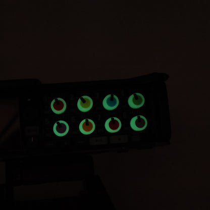 Control panel with glowing green buttons on a dark background