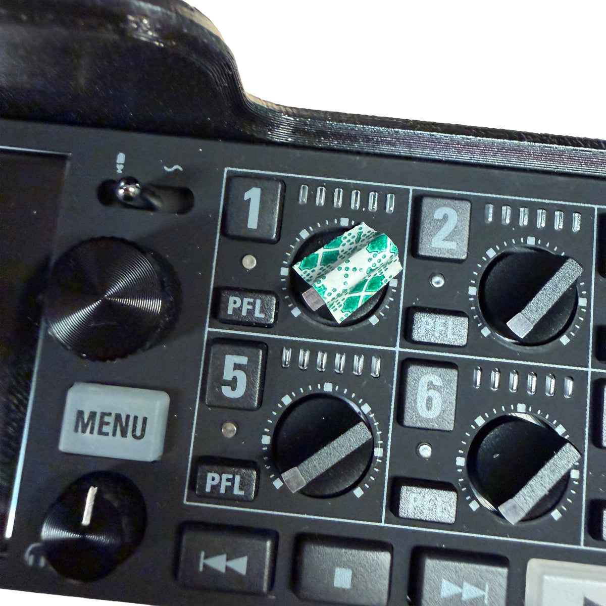 Control panel of a piece of electronic equipment with various buttons and knobs.
