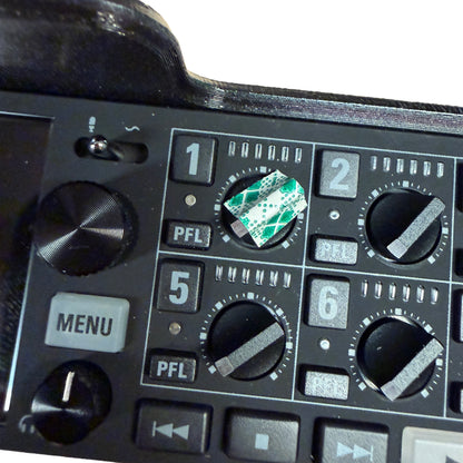Control panel of a piece of electronic equipment with various buttons and knobs.