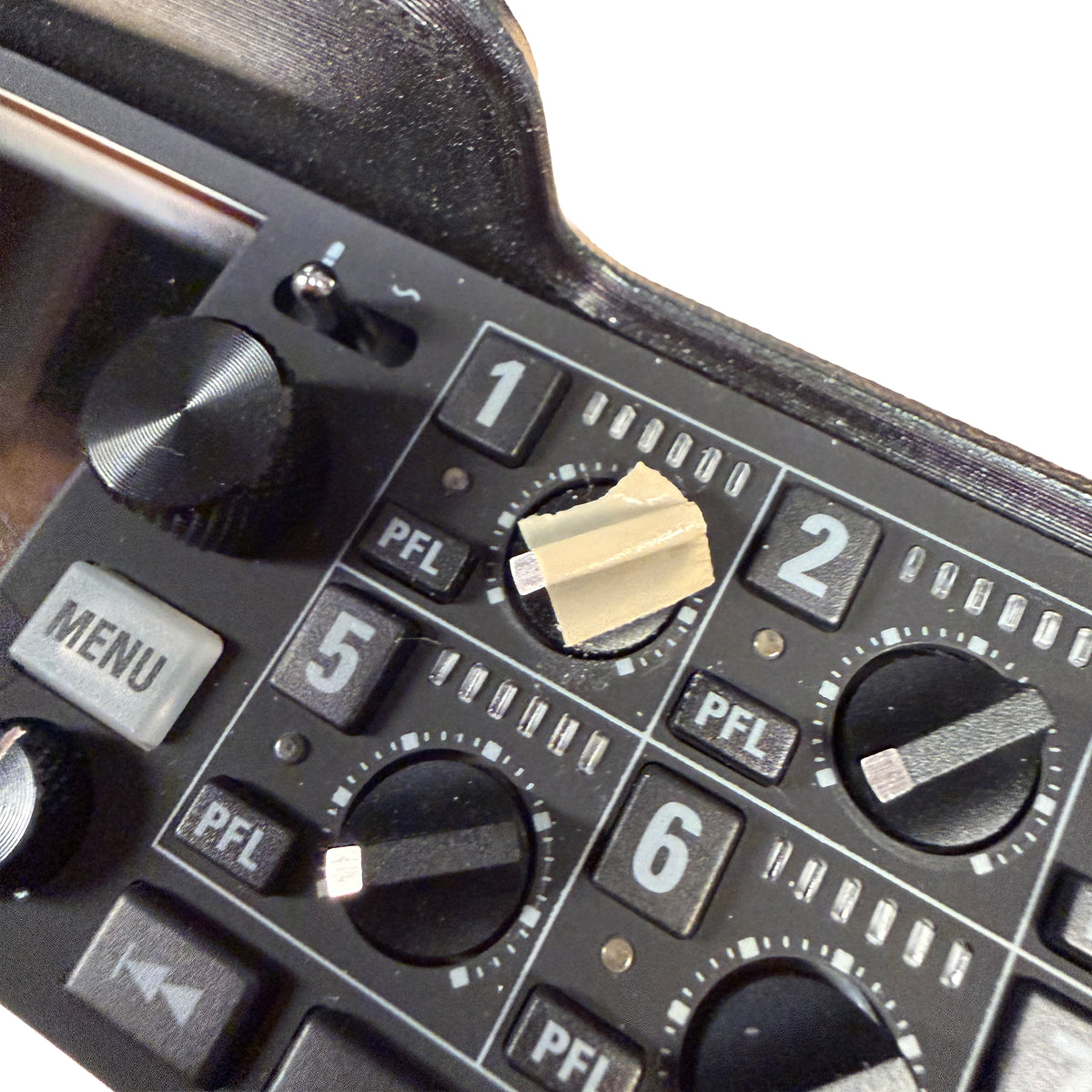 Close-up of a control panel with knobs and buttons on a device.